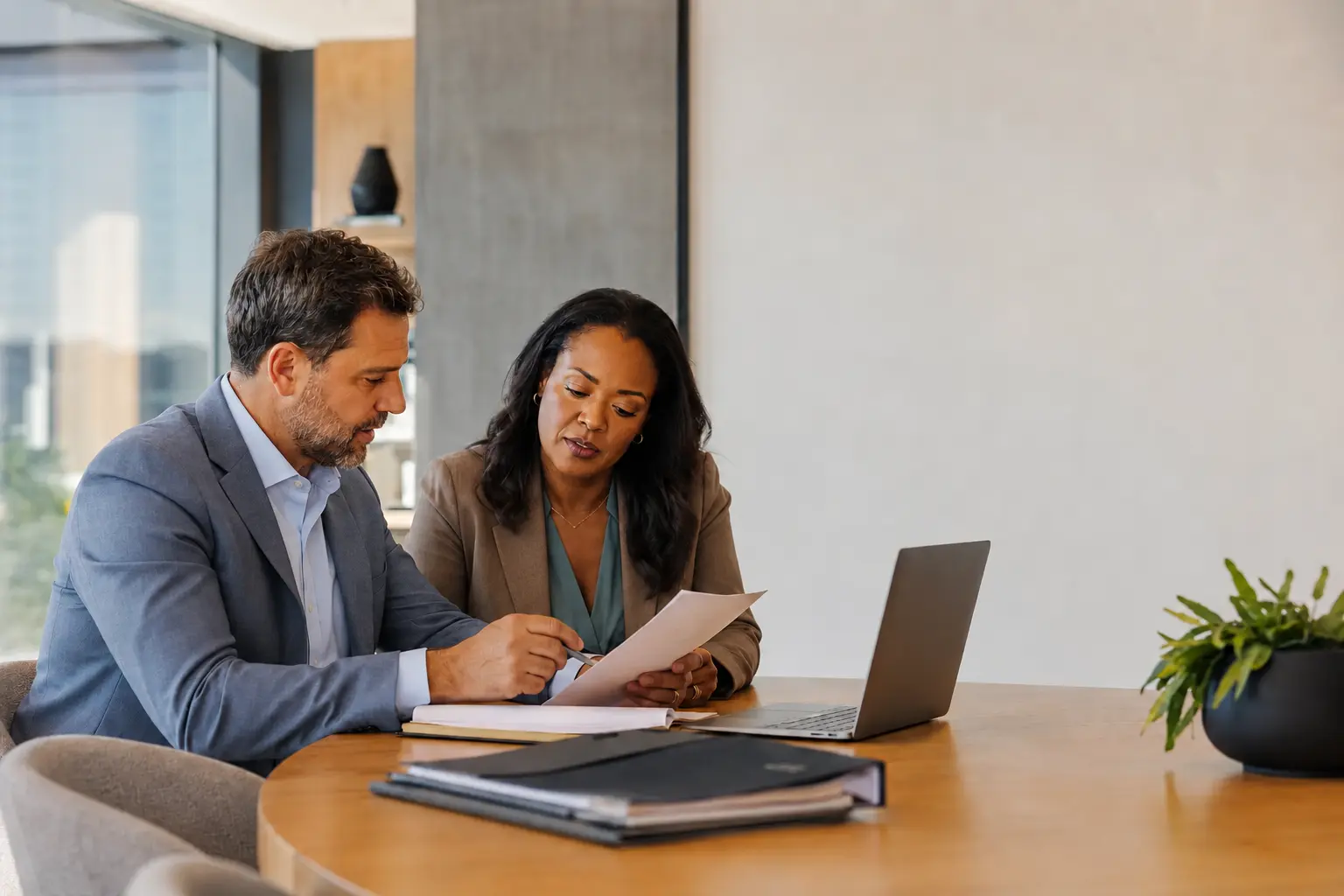 Managing attorney and intake director reviewing new-matter performance together
